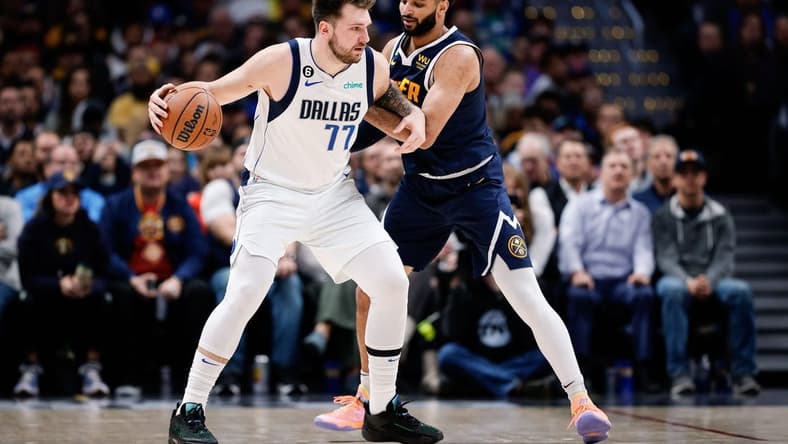 Dec 6, 2022; Denver, Colorado, USA; Dallas Mavericks guard Luka Doncic (77) controls the ball as Denver Nuggets guard Jamal Murray (27) guards in the second quarter at Ball Arena. Mandatory Credit: Isaiah J. Downing-USA TODAY Sports