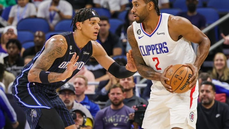 Dec 7, 2022; Orlando, Florida, USA; LA Clippers forward Kawhi Leonard (2) looks to pass in front of Orlando Magic forward Paolo Banchero (5) during the first quarter at Amway Center. Mandatory Credit: Mike Watters-USA TODAY Sports