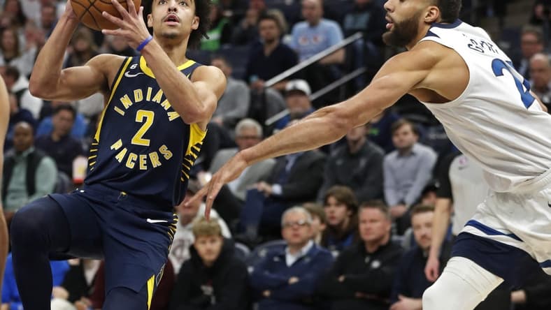 Dec 7, 2022; Minneapolis, Minnesota, USA; Indiana Pacers guard Andrew Nembhard (2) goes to the basket past Minnesota Timberwolves center Rudy Gobert (27) in the first quarter at Target Center. Mandatory Credit: Bruce Kluckhohn-USA TODAY Sports
