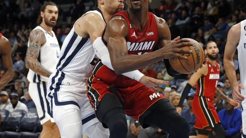 Dec 5, 2022; Memphis, Tennessee, USA; Miami Heat center Bam Adebayo (13) drives to the basket as Memphis Grizzlies forward Dillon Brooks (24) defends during the first half at FedExForum. Mandatory Credit: Petre Thomas-USA TODAY Sports