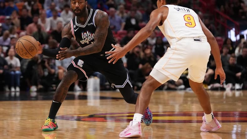 Dec 8, 2022; Miami, Florida, USA; LA Clippers guard John Wall (11) passes the ball away from Miami Heat guard Dru Smith (9) during the first half at FTX Arena. Mandatory Credit: Jasen Vinlove-USA TODAY Sports