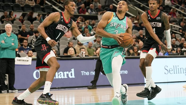 Dec 8, 2022; San Antonio, Texas, USA; San Antonio Spurs forward Keldon Johnson (3) drives to the basket past Houston Rockets forward Jabari Smith Jr. (1) and guard Jalen Green (4) during the first half at AT&T Center. Mandatory Credit: Scott Wachter-USA TODAY Sports