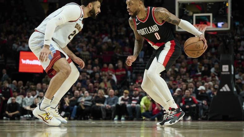 Dec 8, 2022; Portland, Oregon, USA; Denver Nuggets guard Jamal Murray (27) defends Portland Trail Blazers guard Damian Lillard (0) during the first half at Moda Center. Mandatory Credit: Troy Wayrynen-USA TODAY Sports