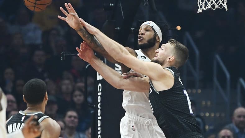 Dec 9, 2022; Cleveland, Ohio, USA; Cleveland Cavaliers forward Lamar Stevens (8) and Sacramento Kings forward Domantas Sabonis (10) go for a rebound during the first half at Rocket Mortgage FieldHouse. Mandatory Credit: Ken Blaze-USA TODAY Sports