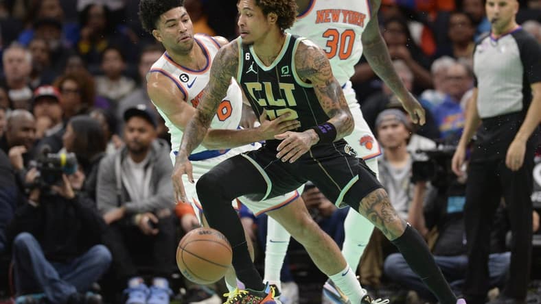Dec 9, 2022; Charlotte, North Carolina, USA; Charlotte Hornets forward Kelly Oubre Jr. (12) drives past New York Knicks guard Quentin Grimes (6) during the first half at the Spectrum Center. Mandatory Credit: Sam Sharpe-USA TODAY Sports