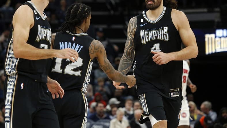 Dec 9, 2022; Memphis, Tennessee, USA; Memphis Grizzlies center Steven Adams (4) reacts with Memphis Grizzlies guard Ja Morant (12) during the first half against the Detroit Pistons at FedExForum. Mandatory Credit: Petre Thomas-USA TODAY Sports