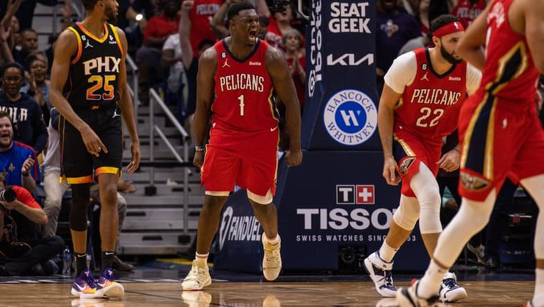 Dec 9, 2022; New Orleans, Louisiana, USA; New Orleans Pelicans forward Zion Williamson (1) reacts to dunking the ball against Phoenix Suns guard Devin Booker (1) and forward Torrey Craig (0) during the second half at Smoothie King Center. Mandatory Credit: Stephen Lew-USA TODAY Sports
