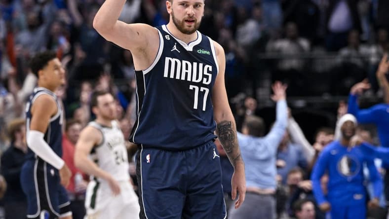 Dec 9, 2022; Dallas, Texas, USA; Dallas Mavericks guard Luka Doncic (77) celebrates forward Maxi Kleber (not pictured) making a three point basket against the Milwaukee Bucks during the second half at the American Airlines Center. Mandatory Credit: Jerome Miron-USA TODAY Sports