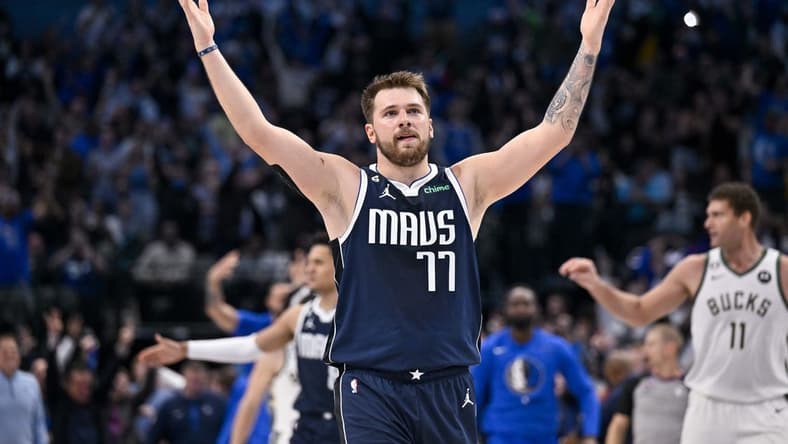 Dec 9, 2022; Dallas, Texas, USA; Dallas Mavericks guard Luka Doncic (77) motions the Mavericks fans during the second half of the game against the Milwaukee Bucks at the American Airlines Center. Mandatory Credit: Jerome Miron-USA TODAY Sports