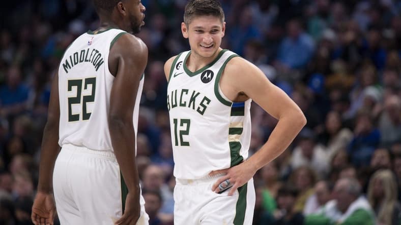 Dec 9, 2022; Dallas, Texas, USA; Milwaukee Bucks forward Khris Middleton (22) and guard Grayson Allen (12) smile during the second half against the Dallas Mavericks at the American Airlines Center. Mandatory Credit: Jerome Miron-USA TODAY Sports