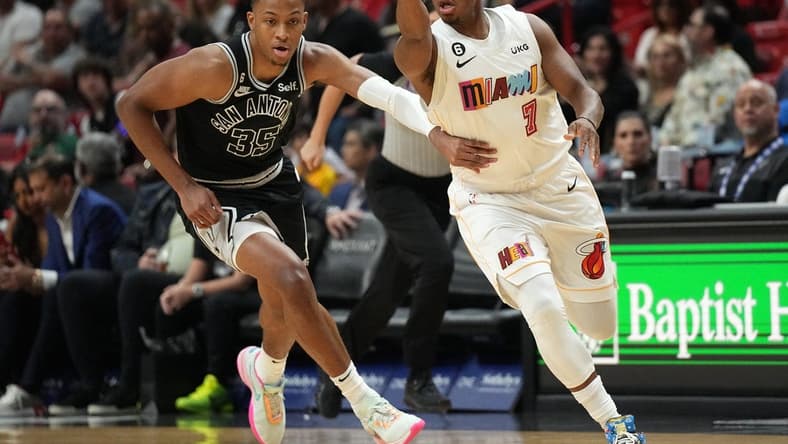 Dec 10, 2022; Miami, Florida, USA; Miami Heat guard Kyle Lowry (7) passes the ball as San Antonio Spurs guard Romeo Langford (35) follows on the play during the first half at FTX Arena. Mandatory Credit: Jim Rassol-USA TODAY Sports