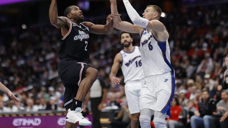 Dec 10, 2022; Washington, District of Columbia, USA; Los Angeles Clippers forward Kawhi Leonard (2) shoots the ball as Washington Wizards center Kristaps Porzingis (6) defends in the fourth quarter at Capital One Arena. Mandatory Credit: Geoff Burke-USA TODAY Sports