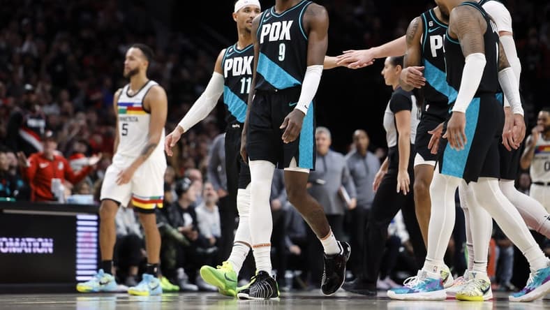 Dec 10, 2022; Portland, Oregon, USA; Portland Trail Blazers shooting guard Josh Hart (11), Jerami Grant (9),  Anfernee Simons (2nd from right), and Damian Lillard (0, right) walk to the bench for a time out during the second half against the Minnesota Timberwolves at Moda Center. Mandatory Credit: Soobum Im-USA TODAY Sports
