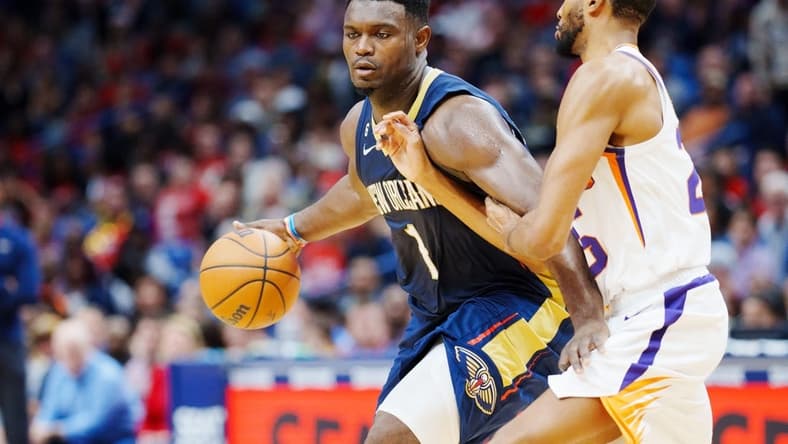 Dec 11, 2022; New Orleans, Louisiana, USA; New Orleans Pelicans forward Zion Williamson (1) fights for position against Phoenix Suns forward Mikal Bridges (25) during the second quarter at Smoothie King Center. Mandatory Credit: Andrew Wevers-USA TODAY Sports