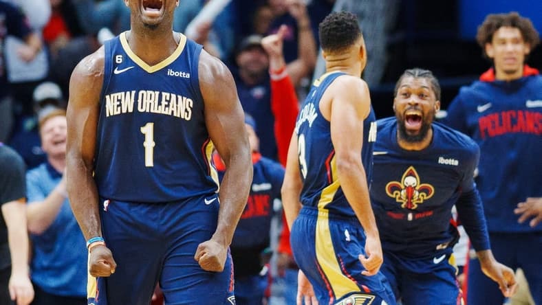 Dec 11, 2022; New Orleans, Louisiana, USA; New Orleans Pelicans forward Zion Williamson (1) reacts to a dunk by guard CJ McCollum (3) during the third quarter against the Phoenix Suns at Smoothie King Center. Mandatory Credit: Andrew Wevers-USA TODAY Sports