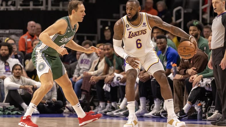 Dec 11, 2022; Detroit, Michigan, USA; Los Angeles Lakers forward LeBron James (6) controls the ball as Detroit Pistons forward Bojan Bogdanovic (44) defends during the in the first half at Little Caesars Arena. Mandatory Credit: David Reginek-USA TODAY Sports