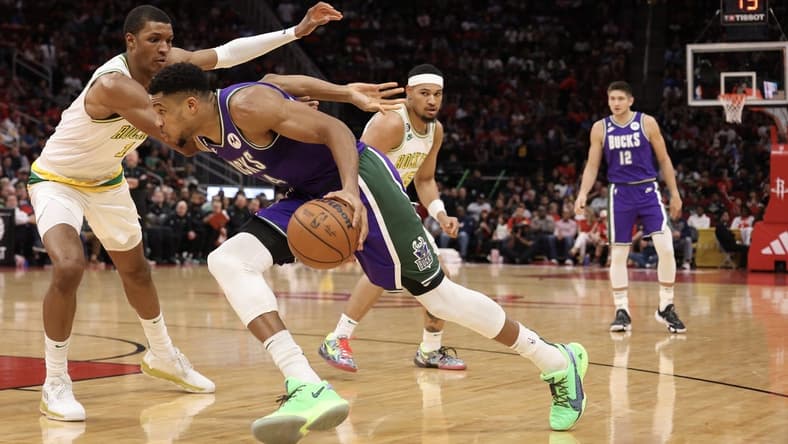 Dec 11, 2022; Houston, Texas, USA; Milwaukee Bucks forward Giannis Antetokounmpo (34) dribbles against Houston Rockets forward Jabari Smith Jr. (1) in the second quarter at Toyota Center. Mandatory Credit: Thomas B. Shea-USA TODAY Sports