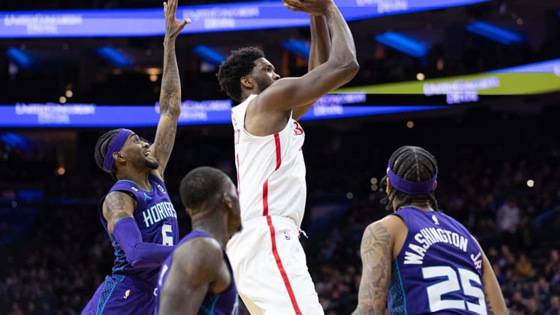 Dec 11, 2022; Philadelphia, Pennsylvania, USA; Philadelphia 76ers center Joel Embiid (21) shoots the ball past Charlotte Hornets forward Jalen McDaniels (6) and forward P.J. Washington (25) and guard Terry Rozier (3) during the fourth quarter at Wells Fargo Center. Mandatory Credit: Bill Streicher-USA TODAY Sports