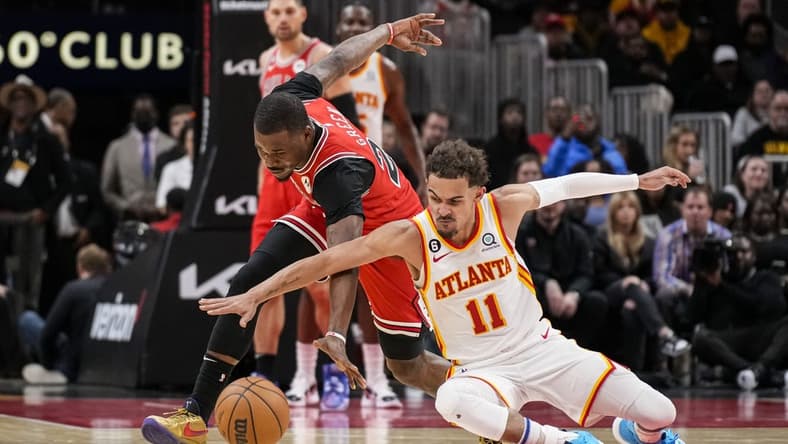 Dec 11, 2022; Atlanta, Georgia, USA; Chicago Bulls forward Javonte Green (24) and Atlanta Hawks guard Trae Young (11) fight for the ball on the floor during the second half at State Farm Arena. Mandatory Credit: Dale Zanine-USA TODAY Sports