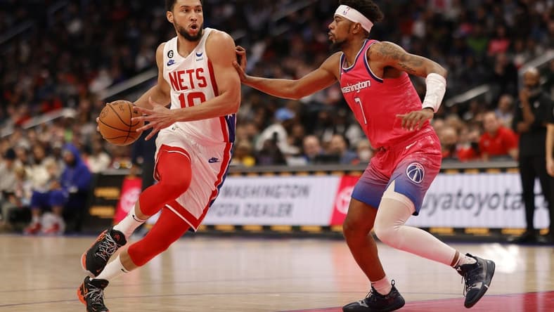 Dec 12, 2022; Washington, District of Columbia, USA; Brooklyn Nets guard Ben Simmons (10) drives to the basket as Washington Wizards guard Jordan Goodwin (7) defends in the second quarter at Capital One Arena. Mandatory Credit: Geoff Burke-USA TODAY Sports