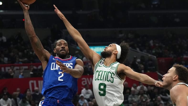 Dec 12, 2022; Los Angeles, California, USA; LA Clippers forward Kawhi Leonard (2) shoots the ball against Boston Celtics guard Derrick White (9) and forward Blake Griffin (91) in the second half at Crypto.com Arena. The Clippers defeated the Celtics 113-93. Mandatory Credit: Kirby Lee-USA TODAY Sports