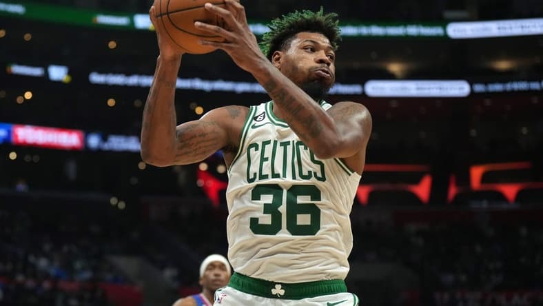 Dec 12, 2022; Los Angeles, California, USA; Boston Celtics guard Marcus Smart (36) rebounds the ball against the LA Clippers in the second half at Crypto.com Arena. The Clippers defeated the Celtics 113-93. Mandatory Credit: Kirby Lee-USA TODAY Sports
