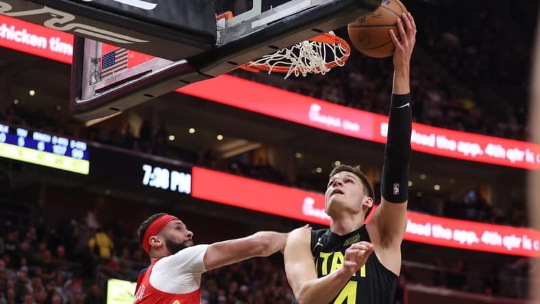 Dec 13, 2022; Salt Lake City, Utah, USA; Utah Jazz center Walker Kessler (24) lays the ball up against New Orleans Pelicans forward Larry Nance Jr. (22) in the second quarter at Vivint Arena. Mandatory Credit: Rob Gray-USA TODAY Sports