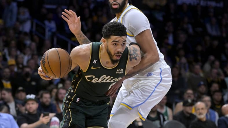 Dec 13, 2022; Los Angeles, California, USA; Boston Celtics forward Jayson Tatum (0) is defended by Los Angeles Lakers forward Anthony Davis (3) as he moves to the basket in the first half at Crypto.com Arena. Mandatory Credit: Jayne Kamin-Oncea-USA TODAY Sports