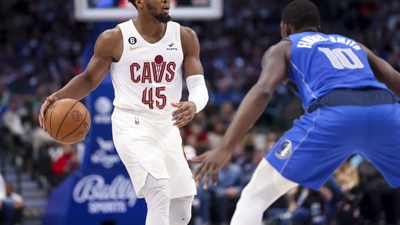 Dec 14, 2022; Dallas, Texas, USA; Cleveland Cavaliers guard Donovan Mitchell (45) controls the ball as Dallas Mavericks forward Dorian Finney-Smith (10) defends during the second quarter at American Airlines Center. Mandatory Credit: Kevin Jairaj-USA TODAY Sports