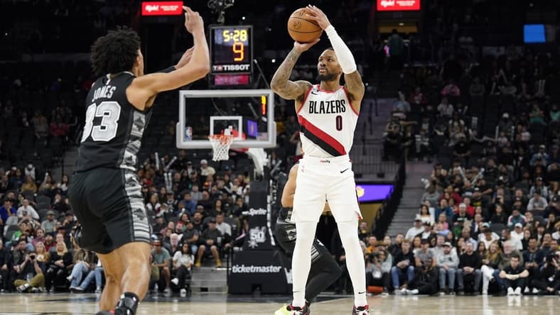 Dec 14, 2022; San Antonio, Texas, USA; Portland Trail Blazers guard Damian Lillard (0) shoots over San Antonio Spurs guard Tre Jones (33) during the second half at AT&T Center. Mandatory Credit: Scott Wachter-USA TODAY Sports