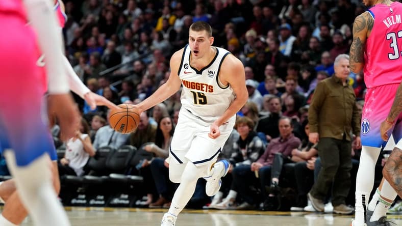 Dec 14, 2022; Denver, Colorado, USA; Denver Nuggets center Nikola Jokic (15) controls the ball in the second half against the Washington Wizards at Ball Arena. Mandatory Credit: Ron Chenoy-USA TODAY Sports