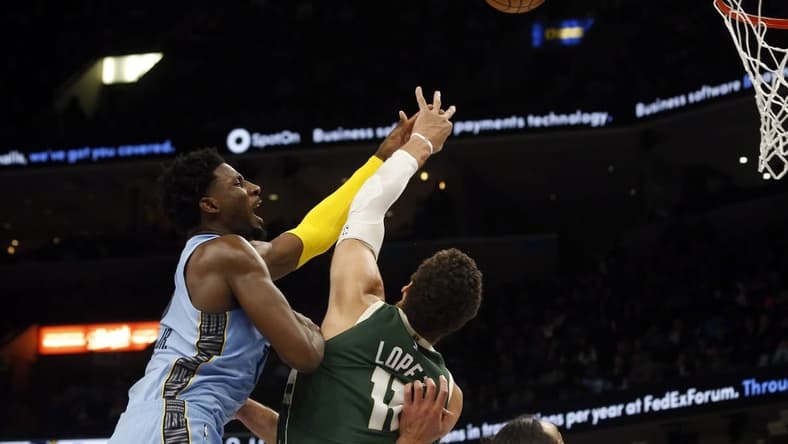 Dec 15, 2022; Memphis, Tennessee, USA; Memphis Grizzlies forward Jaren Jackson Jr. (13) shoots as Milwaukee Bucks center Brook Lopez (11) defends during the first half at FedExForum. Mandatory Credit: Petre Thomas-USA TODAY Sports