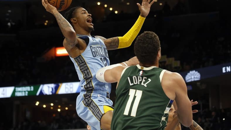Dec 15, 2022; Memphis, Tennessee, USA; Memphis Grizzlies guard Ja Morant (12) shoots during the first half against the Milwaukee Bucks at FedExForum. Mandatory Credit: Petre Thomas-USA TODAY Sports