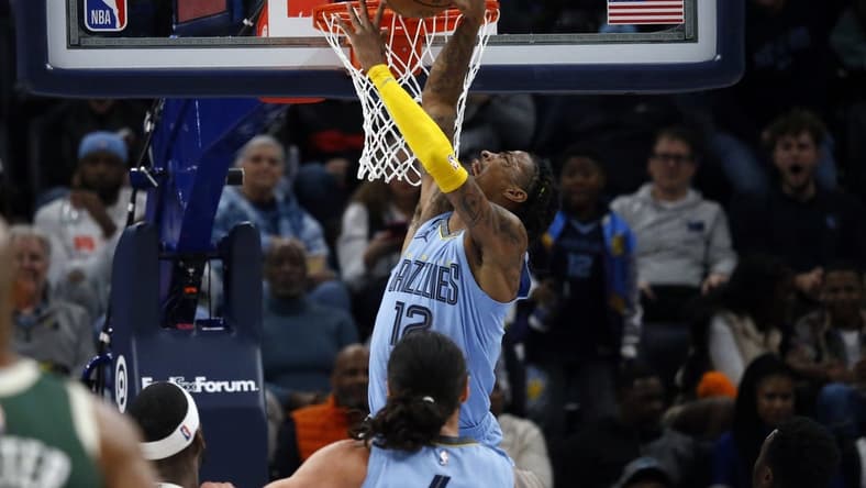 Dec 15, 2022; Memphis, Tennessee, USA; Memphis Grizzlies guard Ja Morant (12) dunks during the second half against the Milwaukee Bucks at FedExForum. Mandatory Credit: Petre Thomas-USA TODAY Sports