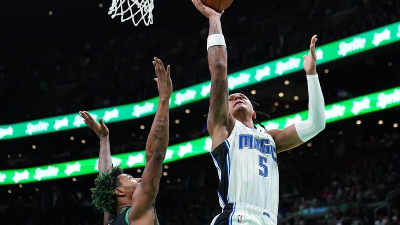 Dec 16, 2022; Boston, Massachusetts, USA; Orlando Magic forward Paolo Banchero (5) shoots againstBoston Celtics guard Marcus Smart (36) in the first quarter at TD Garden. Mandatory Credit: David Butler II-USA TODAY Sports