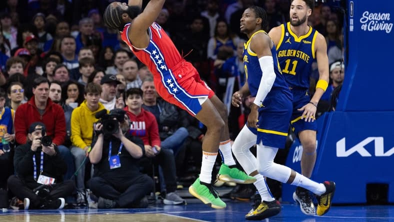 Dec 16, 2022; Philadelphia, Pennsylvania, USA; Philadelphia 76ers guard James Harden (1) is fouled while shooting against Golden State Warriors forward Jonathan Kuminga (00) and guard Klay Thompson (11) during the first quarter at Wells Fargo Center. Mandatory Credit: Bill Streicher-USA TODAY Sports