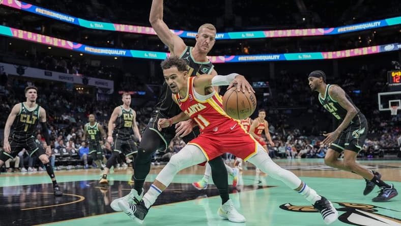 Dec 16, 2022; Charlotte, North Carolina, USA; Atlanta Hawks guard Trae Young (11) drives to the basket against Charlotte Hornets center Mason Plumlee (24) during first quarter at Spectrum Center. Mandatory Credit: Jim Dedmon-USA TODAY Sports