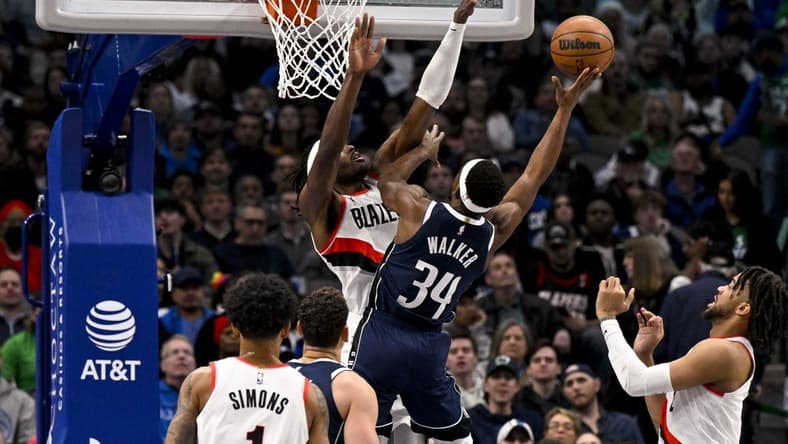 Dec 16, 2022; Dallas, Texas, USA; Dallas Mavericks guard Kemba Walker (34) shoots over Portland Trail Blazers forward Jerami Grant (9) during the second quarter at the American Airlines Center. Mandatory Credit: Jerome Miron-USA TODAY Sports