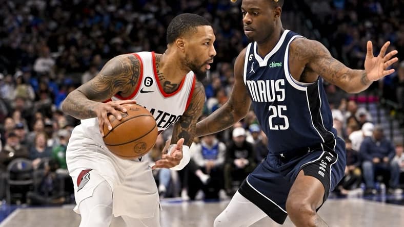 Dec 16, 2022; Dallas, Texas, USA; Portland Trail Blazers guard Damian Lillard (0) looks to dribble past Dallas Mavericks forward Reggie Bullock (25) during the second quarter at the American Airlines Center. Mandatory Credit: Jerome Miron-USA TODAY Sports