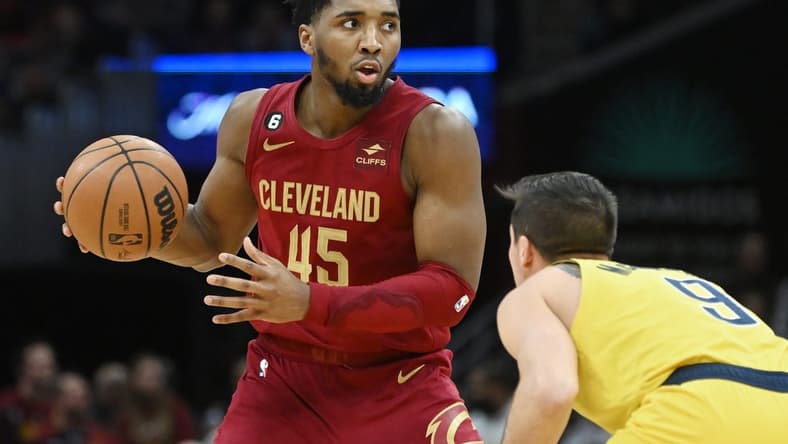 Dec 16, 2022; Cleveland, Ohio, USA; Cleveland Cavaliers guard Donovan Mitchell (45) controls the ball against Indiana Pacers guard T.J. McConnell (9) during the second half at Rocket Mortgage FieldHouse. Mandatory Credit: Ken Blaze-USA TODAY Sports
