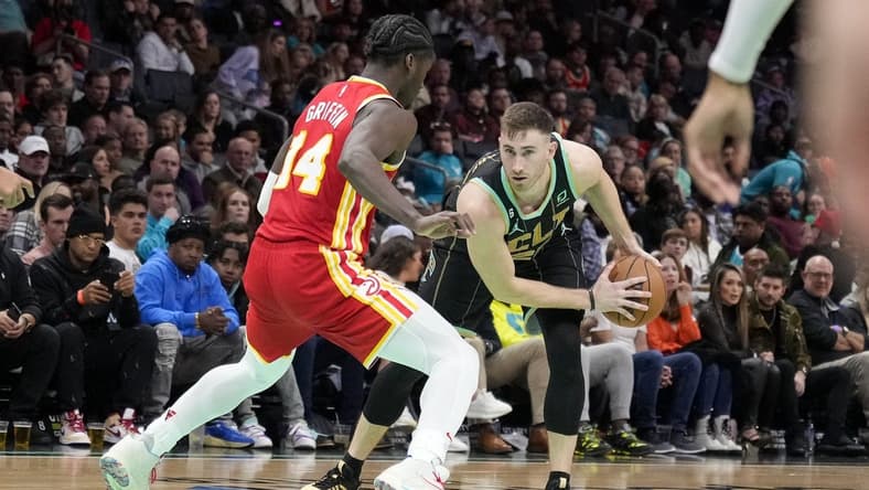Dec 16, 2022; Charlotte, North Carolina, USA; Charlotte Hornets forward Gordon Hayward (20) looks to make a break from Atlanta Hawks forward AJ Griffin (14) during the second half at Spectrum Center. Mandatory Credit: Jim Dedmon-USA TODAY Sports