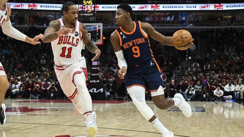Dec 16, 2022; Chicago, Illinois, USA; New York Knicks guard RJ Barrett (9) dribbles past Chicago Bulls forward DeMar DeRozan (11) during the second half at the United Center. Mandatory Credit: Matt Marton-USA TODAY Sports