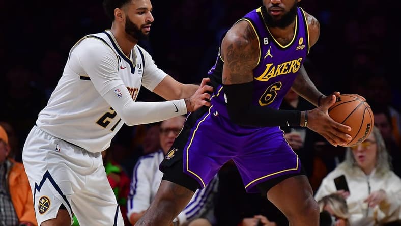 Dec 16, 2022; Los Angeles, California, USA; Los Angeles Lakers forward LeBron James (6) controls the ball against Denver Nuggets guard Jamal Murray (27) during the first half at Crypto.com Arena. Mandatory Credit: Gary A. Vasquez-USA TODAY Sports