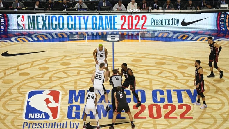 Dec 17, 2022; Mexico City, MEX; San Antonio Spurs center Jakob Poeltl (25) and Miami Heat center Bam Adebayo (13) await the opening tipoff from referee Matt Boland (18) during the NBA Mexico City Game 2022 at the Arena de Ciudad de Mexico. Mandatory Credit: Kirby Lee-USA TODAY Sports