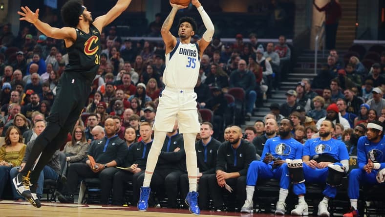 Dec 17, 2022; Cleveland, Ohio, USA;  Dallas Mavericks forward Christian Wood (35) shoots the ball against Cleveland Cavaliers center Jarrett Allen (31) during the first quarter at Rocket Mortgage FieldHouse. Mandatory Credit: Aaron Josefczyk-USA TODAY Sports