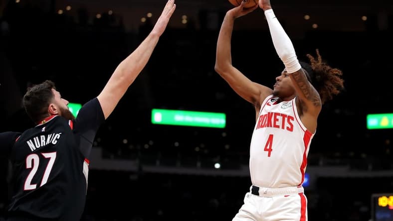 Dec 17, 2022; Houston, Texas, USA; Houston Rockets guard Jalen Green (4) takes a jumps shot while Portland Trail Blazers center Jusuf Nurkic (27) defends during the first quarter at Toyota Center. Mandatory Credit: Erik Williams-USA TODAY Sports