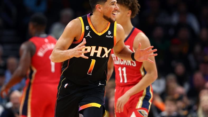 Dec 17, 2022; Phoenix, Arizona, USA; Phoenix Suns guard Devin Booker (1) reacts against the New Orleans Pelicans at Footprint Center. Mandatory Credit: Mark J. Rebilas-USA TODAY Sports
