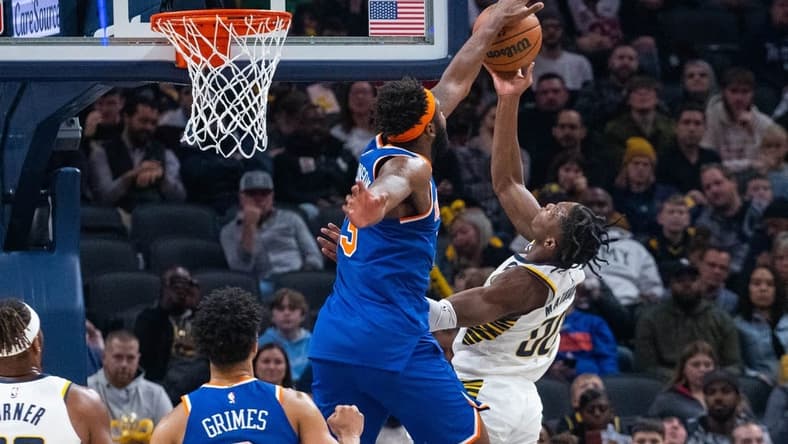 Dec 18, 2022; Indianapolis, Indiana, USA; Indiana Pacers guard Bennedict Mathurin (00) shoots the ball while New York Knicks center Mitchell Robinson (23) defends in the second quarter at Gainbridge Fieldhouse. Mandatory Credit: Trevor Ruszkowski-USA TODAY Sports