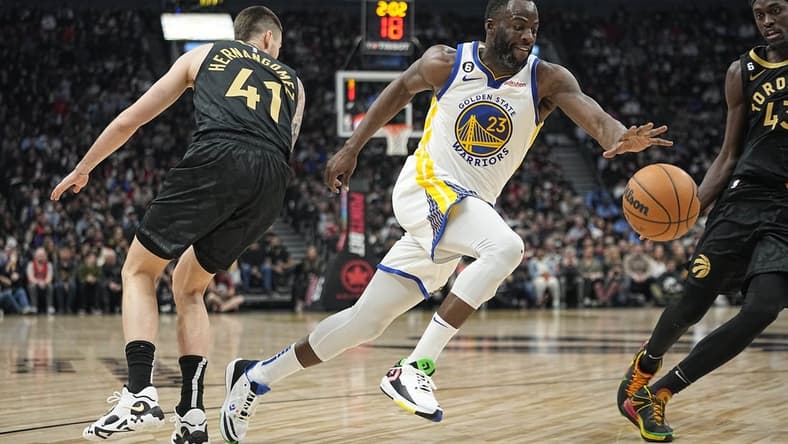 Dec 18, 2022; Toronto, Ontario, CAN; Golden State Warriors forward Draymond Green (23) drives to the net past Toronto Raptors forward Juancho Hernangomez (41) during the first half at Scotiabank Arena. Mandatory Credit: John E. Sokolowski-USA TODAY Sports