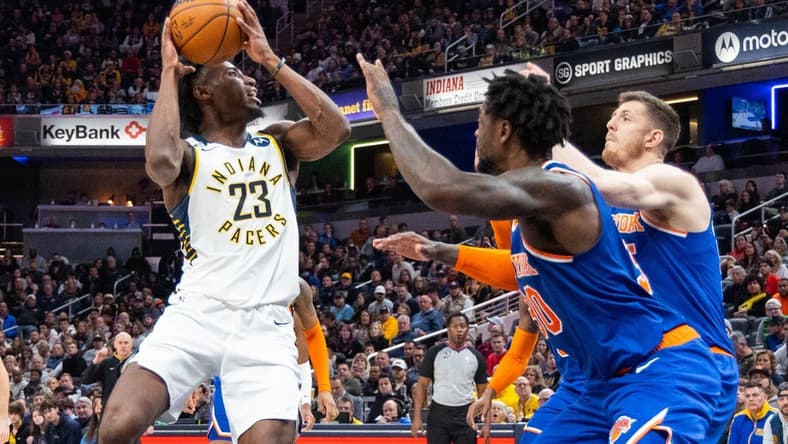 Dec 18, 2022; Indianapolis, Indiana, USA; Indiana Pacers forward Aaron Nesmith (23) shoots the ball while New York Knicks forward Julius Randle (30) defends in the second half at Gainbridge Fieldhouse. Mandatory Credit: Trevor Ruszkowski-USA TODAY Sports